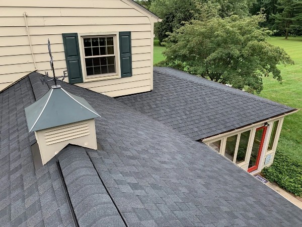 new asphalt shingle roof on tan house